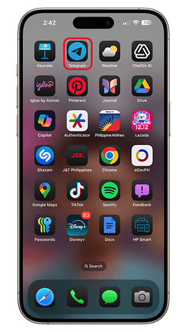 iOS 18 home screen featuring various app icons including Telegram, Spotify, and Disney+.