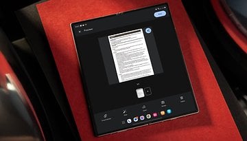 A tablet displaying a document preview on a red background.