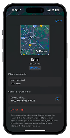 A phone screen displaying a map of Berlin, with download status for an Apple Watch.