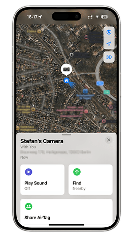 Apple device displaying a map with a camera location and options to play sound, find nearby, and share AirTag.