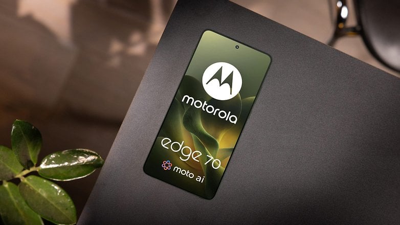 A Motorola Edge 70 smartphone laying on a black surface, showcasing its logo and screen design. A Motorola Edge 70 smartphone laying on a black surface, showcasing its logo and screen design.