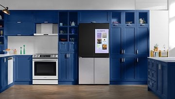 A modern kitchen featuring a Samsung refrigerator with a display, blue cabinetry, and a stainless steel oven.