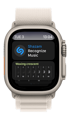 Apple Watch mostrando o aplicativo Shazam e a fase lunar da lua crescente.