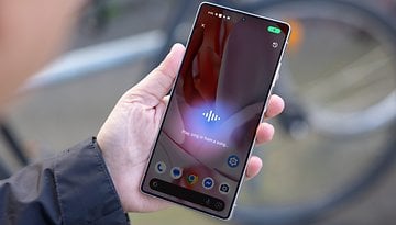 A person holding a Samsung Galaxy S25 Ultra smartphone displaying a music recognition interface.