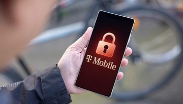 A hand holding a smartphone displaying the T-Mobile logo with a padlock icon.