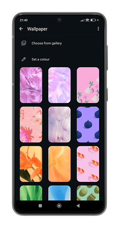 A smartphone screen displaying a variety of colorful wallpaper options for WhatsApp chat themes.