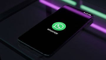 A smartphone displaying the WhatsApp logo on a black screen.
