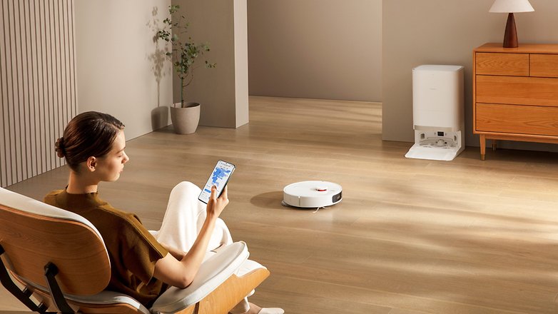 Xiaomi Robot Vacuum X20+ im Einsatz in einem Wohnzimmer, während er von einer Frau per Smartphone gesteuert wird