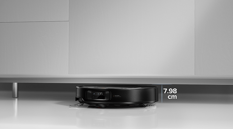 Roborock Saros Z70 vacuum robot positioned under a cabinet, height marked as 7.98 cm.