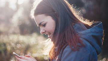 Eine Frau schaut auf ihr Handy