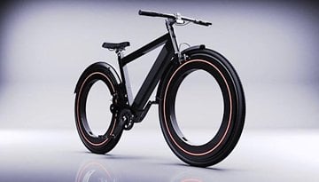 Ein elegantes Noll Go E-Bike mit einzigartigen runden Reifen und einem schwarzen Rahmen, vor einem hellen Hintergrund.