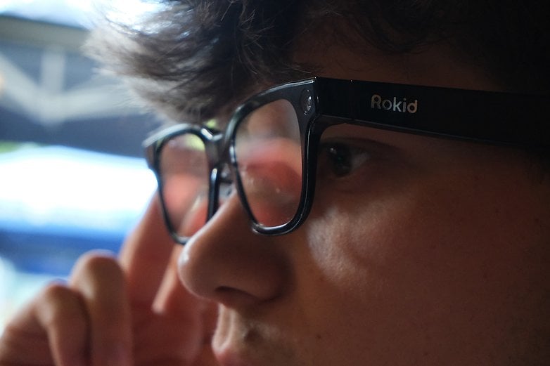 Close-up of Rokid glasses worn by a person, with a focus on the lenses and frame.