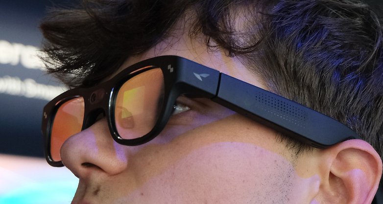 Close-up of a person wearing TCL RayNeo X3 Pro smart glasses.